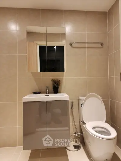 Modern bathroom with sleek fixtures and neutral tiles