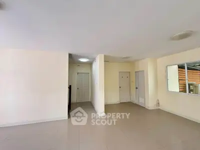 Spacious interior with neutral tones and tiled flooring, ideal for customization.