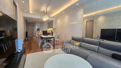 Luxurious modern living room with sleek furniture and open kitchen layout.