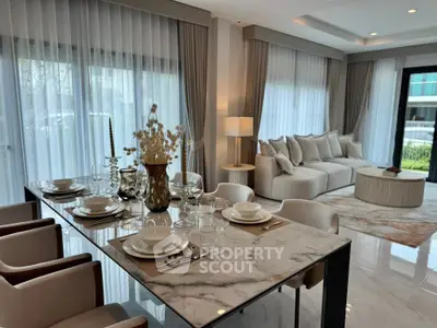 Luxurious open-plan living and dining area with elegant decor and natural light.