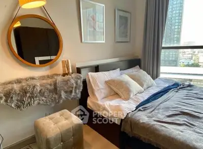 Stylish bedroom with modern decor and city view, featuring cozy bedding and elegant furnishings.