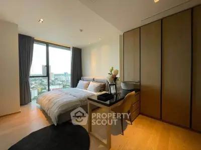 Modern bedroom with city view, featuring sleek furniture and large window for natural light.