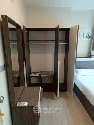 Modern bedroom with open wardrobe and stylish wooden furniture