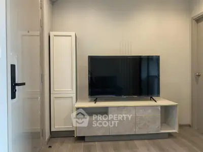 Modern living room with sleek TV stand and flat-screen TV, perfect for entertainment.
