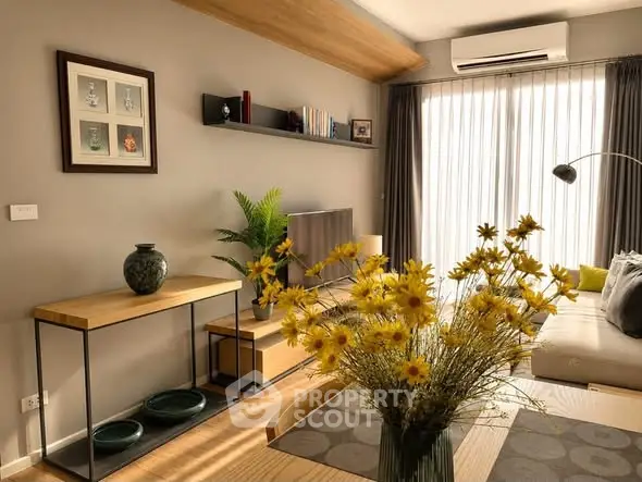 Stylish living room with modern decor, large window, and cozy seating area.