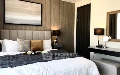 Luxurious bedroom with elegant decor and cozy ambiance, featuring plush bedding and stylish lighting.