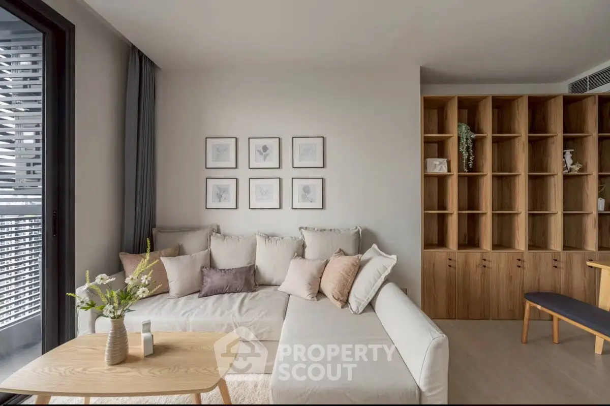 Modern living room with cozy sectional sofa and stylish wooden shelving unit.