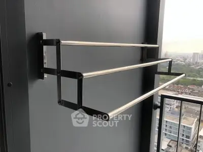 Modern balcony with sleek stainless steel towel rack and city view