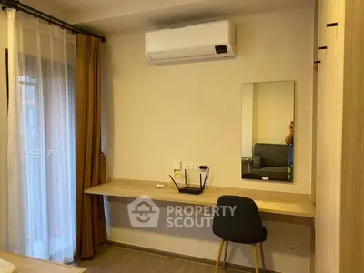 Modern study area with desk, chair, and air conditioning in a cozy apartment.