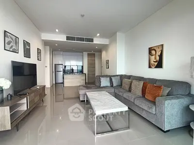 Modern living room with sleek furniture and open kitchen layout