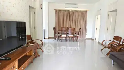 Spacious living room with modern furniture and large TV in elegant home