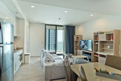 Modern living room with open kitchen and balcony view in stylish apartment