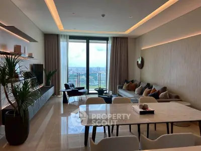 Luxurious living room with modern decor and stunning city view from large windows.