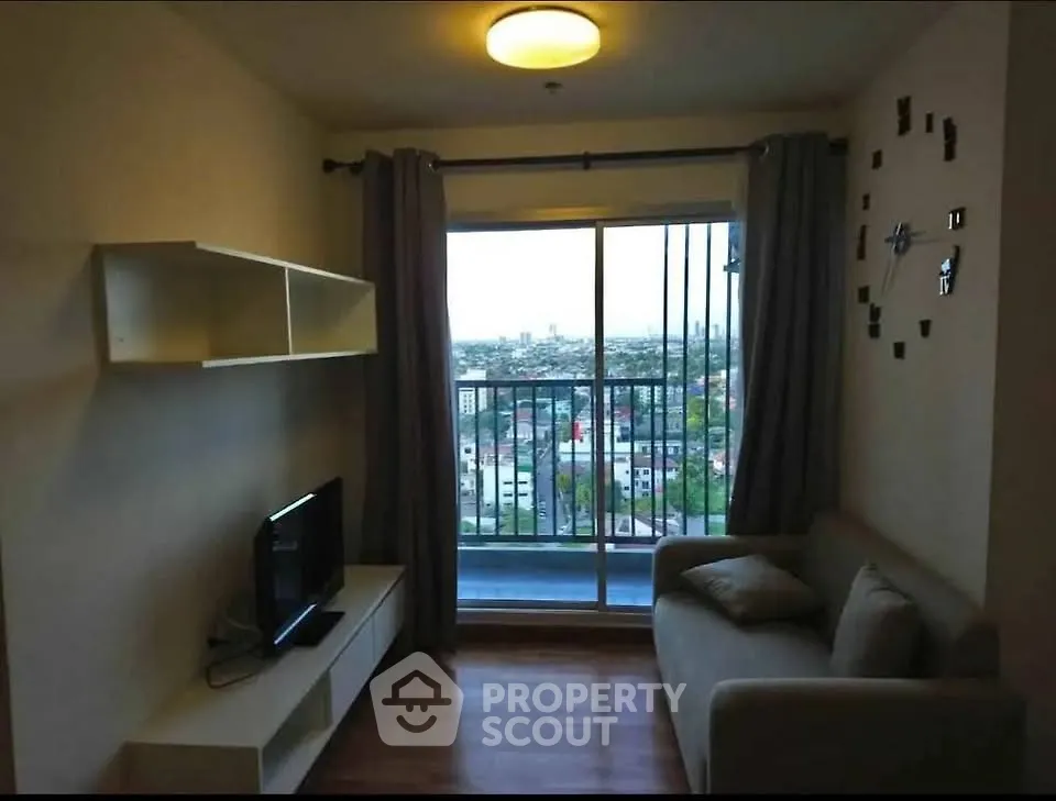 Cozy living room with balcony and city view, perfect for relaxation.