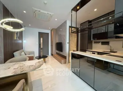 Modern open-layout living room and kitchen with sleek design and luxurious finishes.