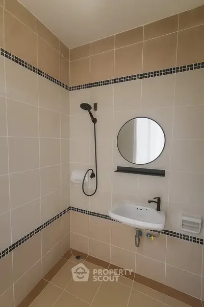 Modern bathroom with sleek shower and round mirror
