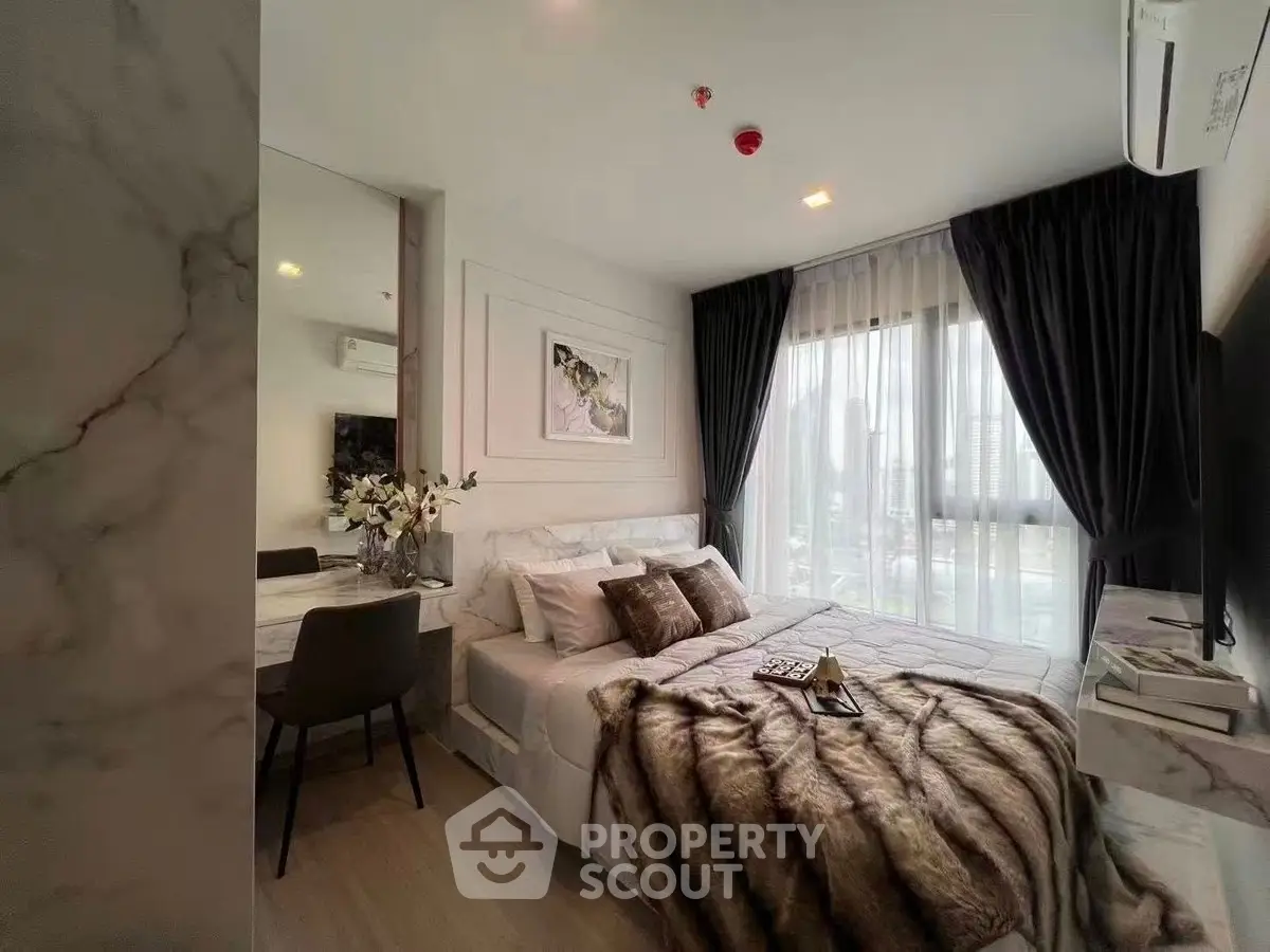 Luxurious bedroom with elegant decor and city view, featuring plush bedding and modern furnishings.