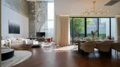 Luxurious modern living room with high ceilings and elegant dining area, featuring floor-to-ceiling windows.