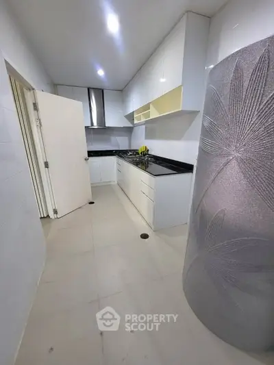 Modern kitchen with sleek cabinetry and gas stove in a compact layout