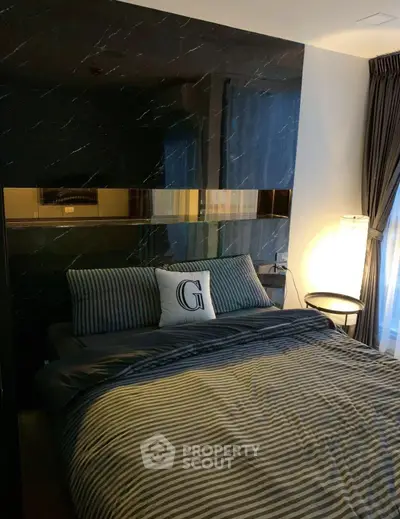 Luxurious bedroom with elegant decor and ambient lighting, featuring a stylish bed and modern furnishings.