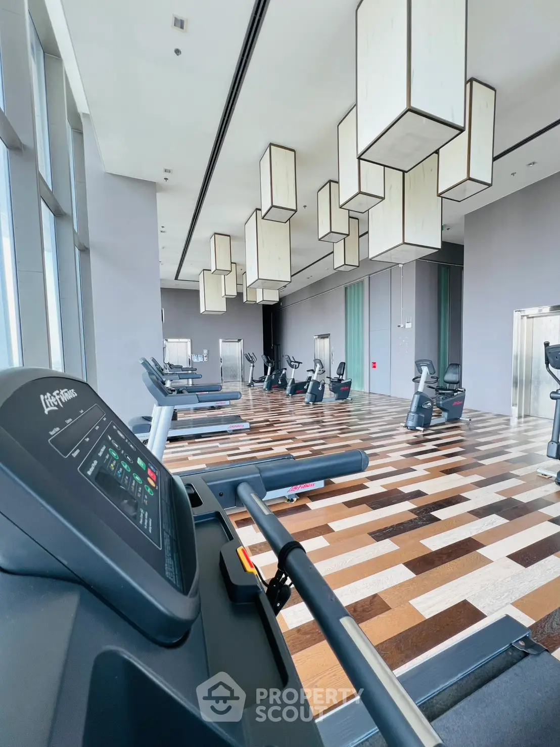 Spacious modern gym with state-of-the-art equipment and stylish lighting