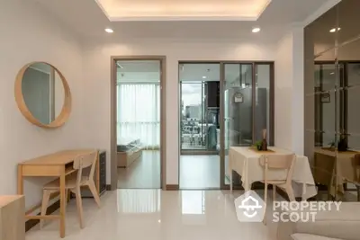 Modern living room with sleek design and glass doors leading to a balcony with city view.