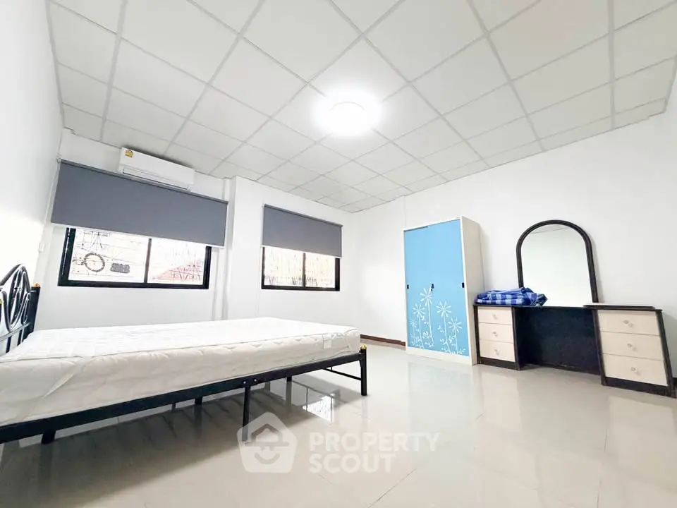 Spacious bedroom with modern furnishings and ample natural light