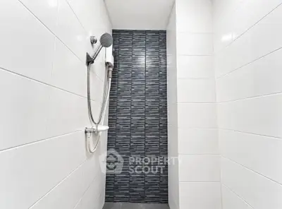 Modern bathroom shower with sleek tile design and contemporary fixtures.