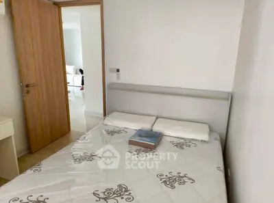 Cozy bedroom with elegant decor and natural light, perfect for relaxation and comfort.