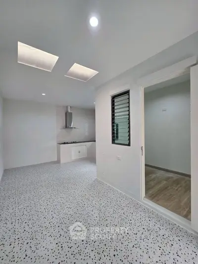 Modern kitchen with terrazzo flooring and sleek design in open layout