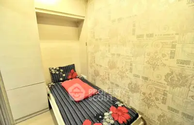 Cozy bedroom with floral bedding and modern wallpaper, perfect for a compact living space.