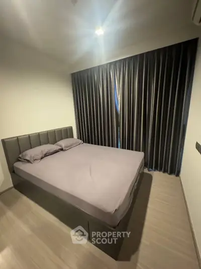 Cozy bedroom with modern decor and elegant curtains, perfect for restful nights.
