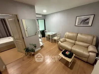 Cozy living room with beige sofa, dining table, and modern decor in a stylish apartment.