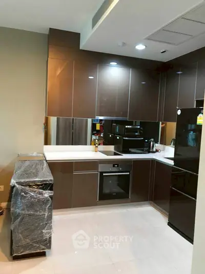 Modern kitchen with sleek cabinets and built-in appliances in a stylish apartment.