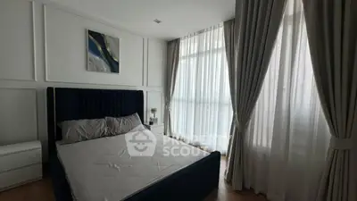 Elegant bedroom with large windows and stylish curtains