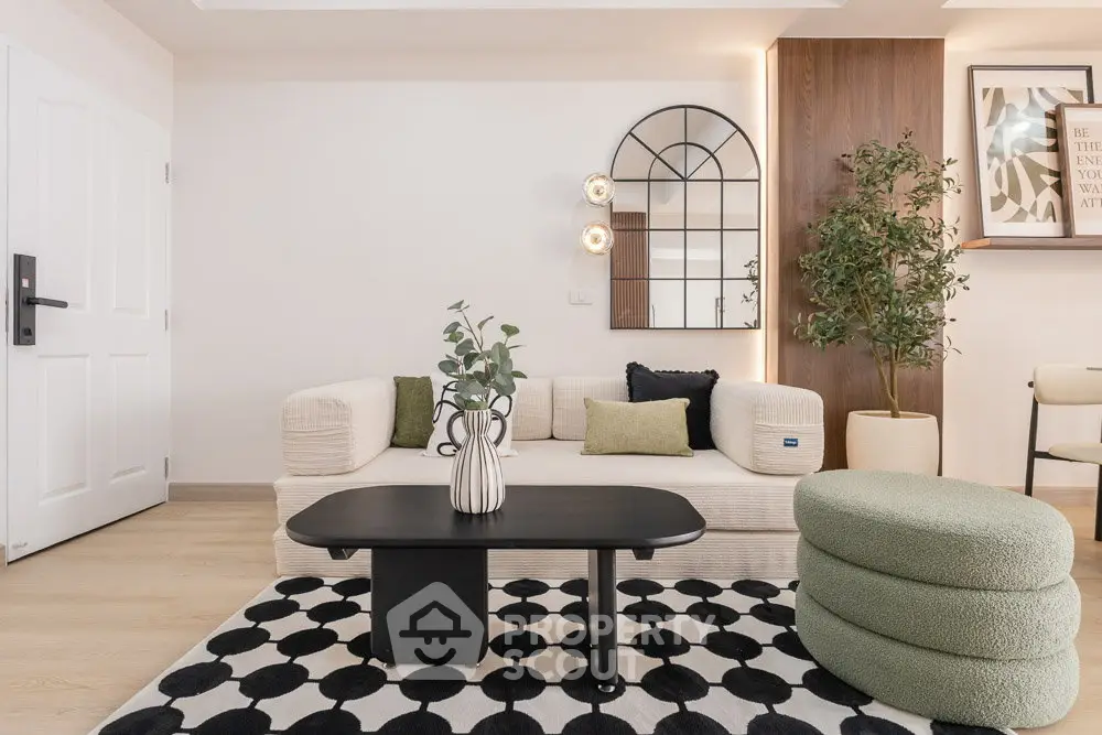 Modern living room with stylish decor, featuring a cozy sofa, chic coffee table, and elegant wall mirror.