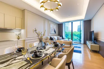 Luxurious modern living room with elegant dining area and city view balcony.