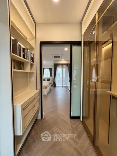 Luxurious apartment hallway leading to spacious living room with elegant decor and natural light.