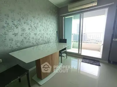 Modern dining area with sleek table and balcony view in stylish apartment.