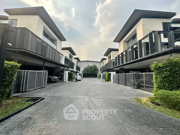 Modern townhouse complex with sleek architecture and spacious driveways.