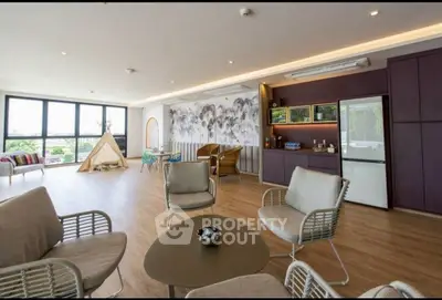 Spacious modern living room with elegant decor and large windows offering natural light.