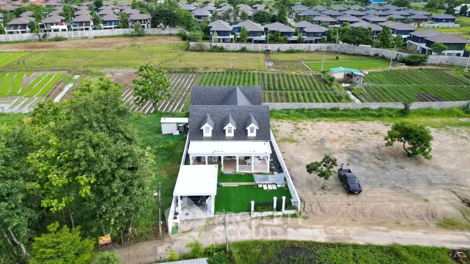 Charming countryside house with lush greenery and spacious surroundings, perfect for serene living.