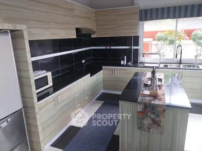 Modern kitchen with sleek black countertops and stylish cabinetry