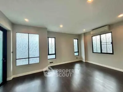 Spacious modern living room with large windows and sleek flooring