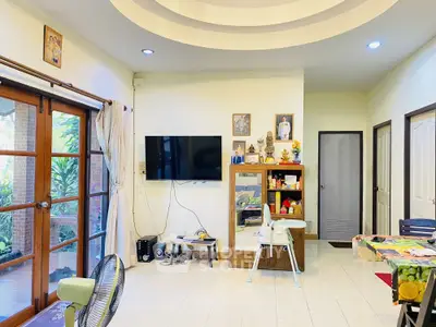 Spacious living room with modern decor and large windows for natural light.