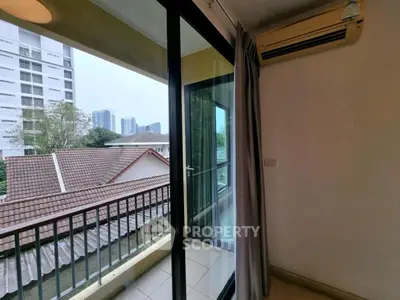 Charming balcony view from modern apartment with cityscape backdrop.