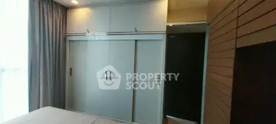 Modern bedroom with sleek built-in wardrobe and stylish wooden paneling