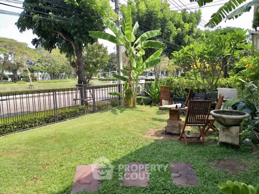Charming garden with lush greenery and outdoor seating, perfect for relaxation and entertaining.