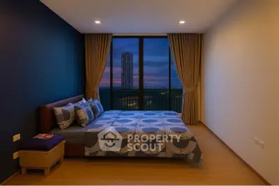 Spacious bedroom with modern decor and stunning city view from large window.