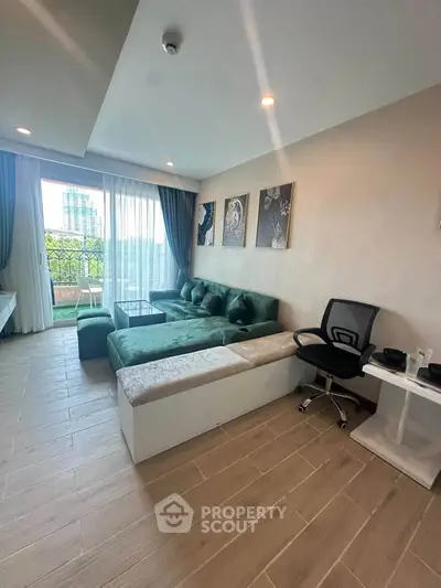 Modern living room with stylish decor and large windows offering a scenic view.